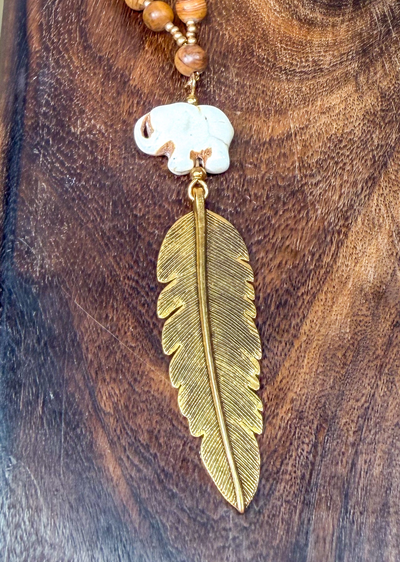 Hand Carved Stone Elephant Charm with Dark Gold Feather Pendant Long Necklace with Stone beads accents