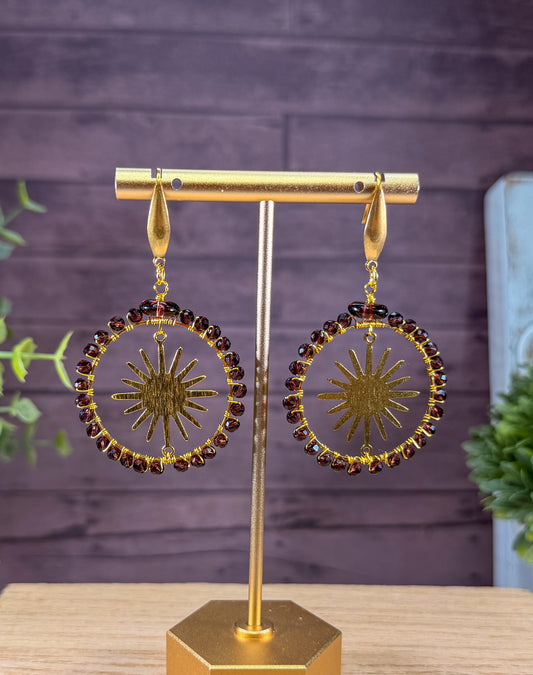 Crystal Faceted deep Lavender Crystals framing a golden sunburst Earrings