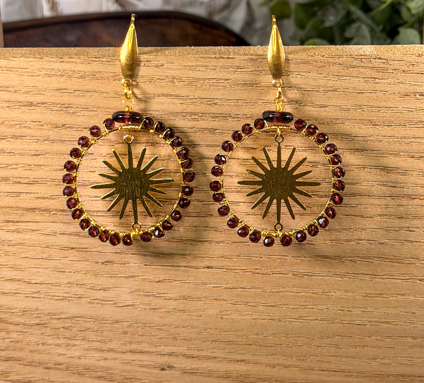 Crystal Faceted deep Lavender Crystals framing a golden sunburst Earrings