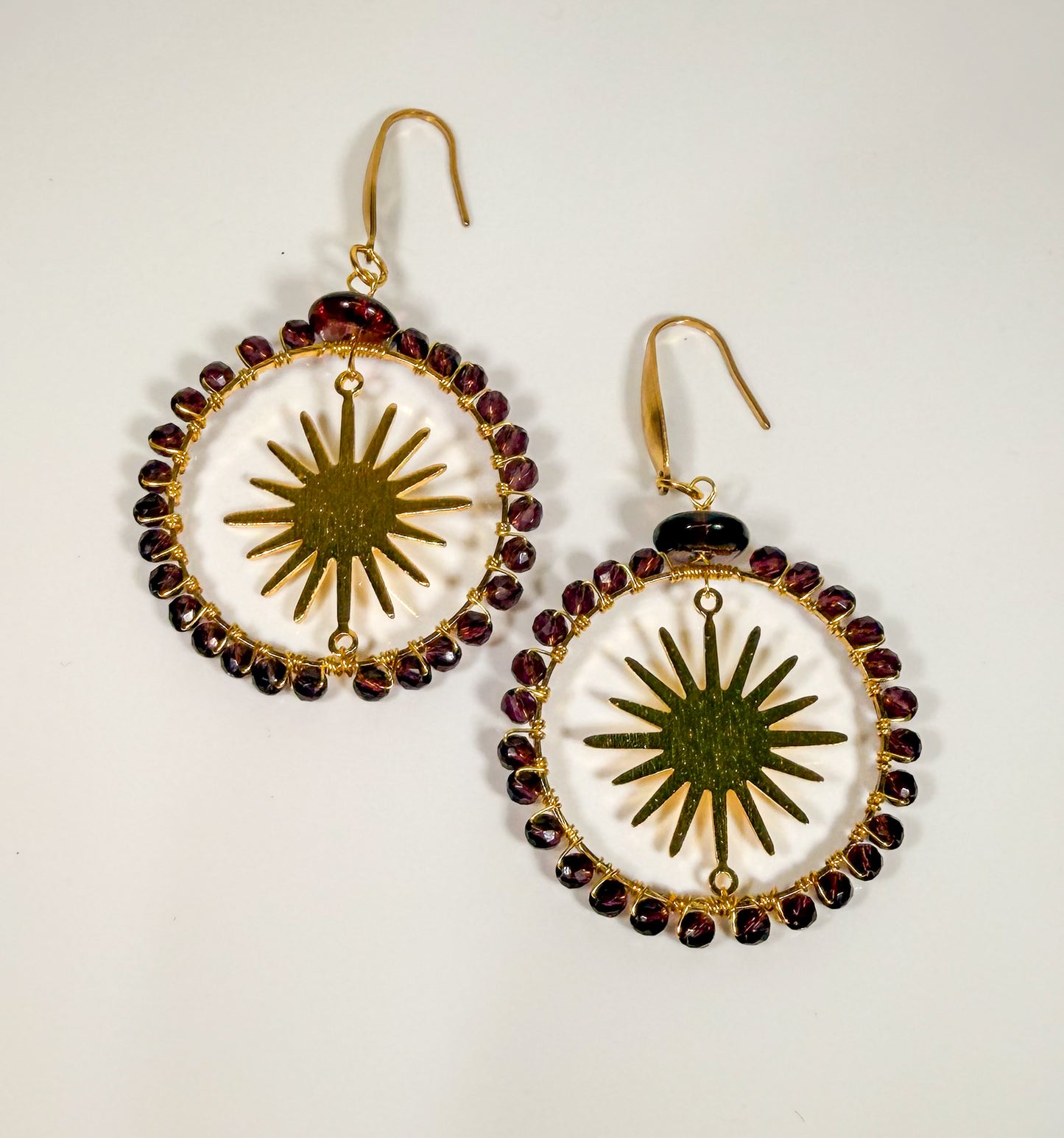Crystal Faceted deep Lavender Crystals framing a golden sunburst Earrings