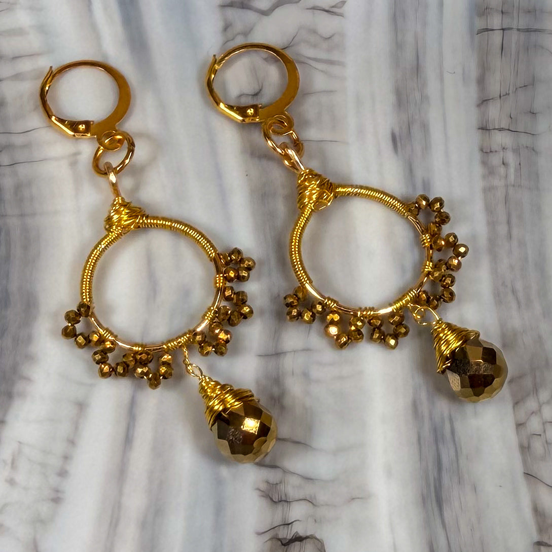 Gold sunburst hoop earrings with crystal tear drop wire wrapped charm with huggie closure and gold crystal beads