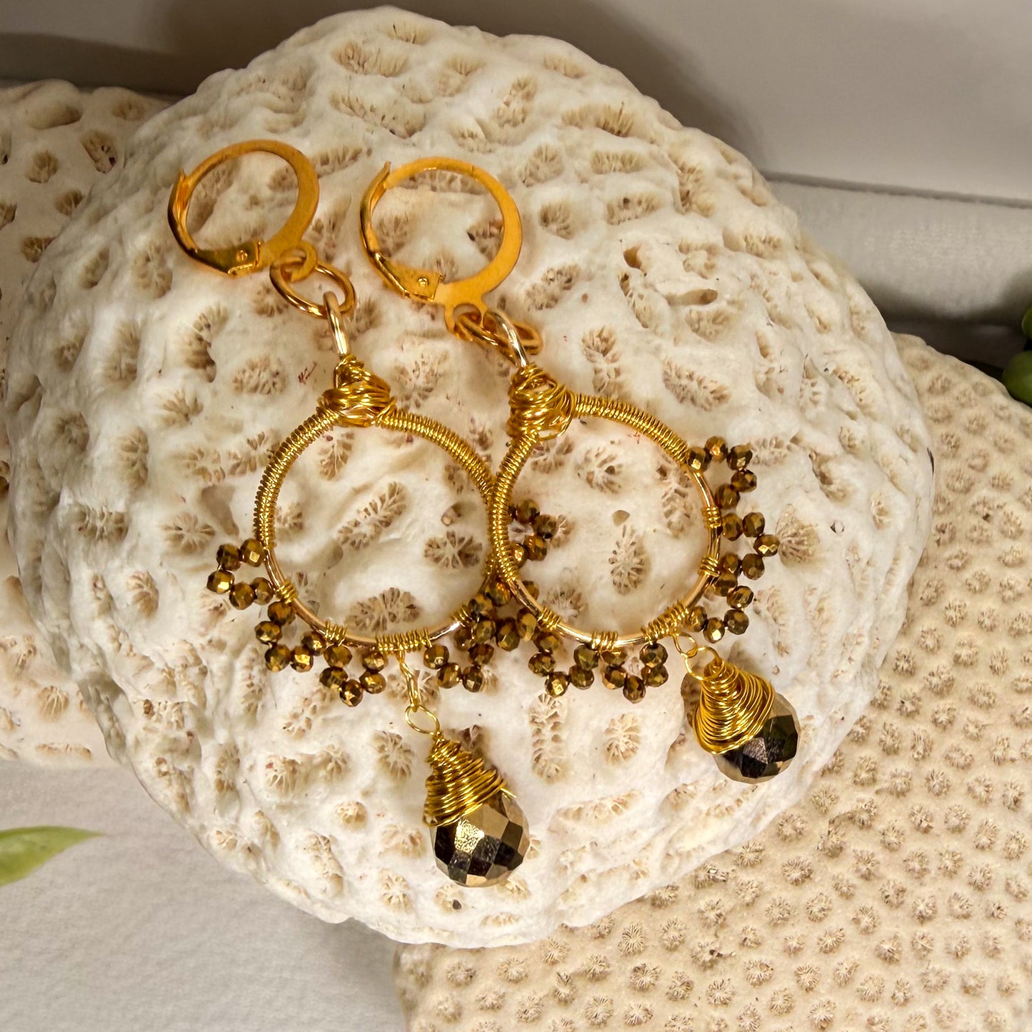 Gold sunburst hoop earrings with crystal tear drop wire wrapped charm with huggie closure and gold crystal beads