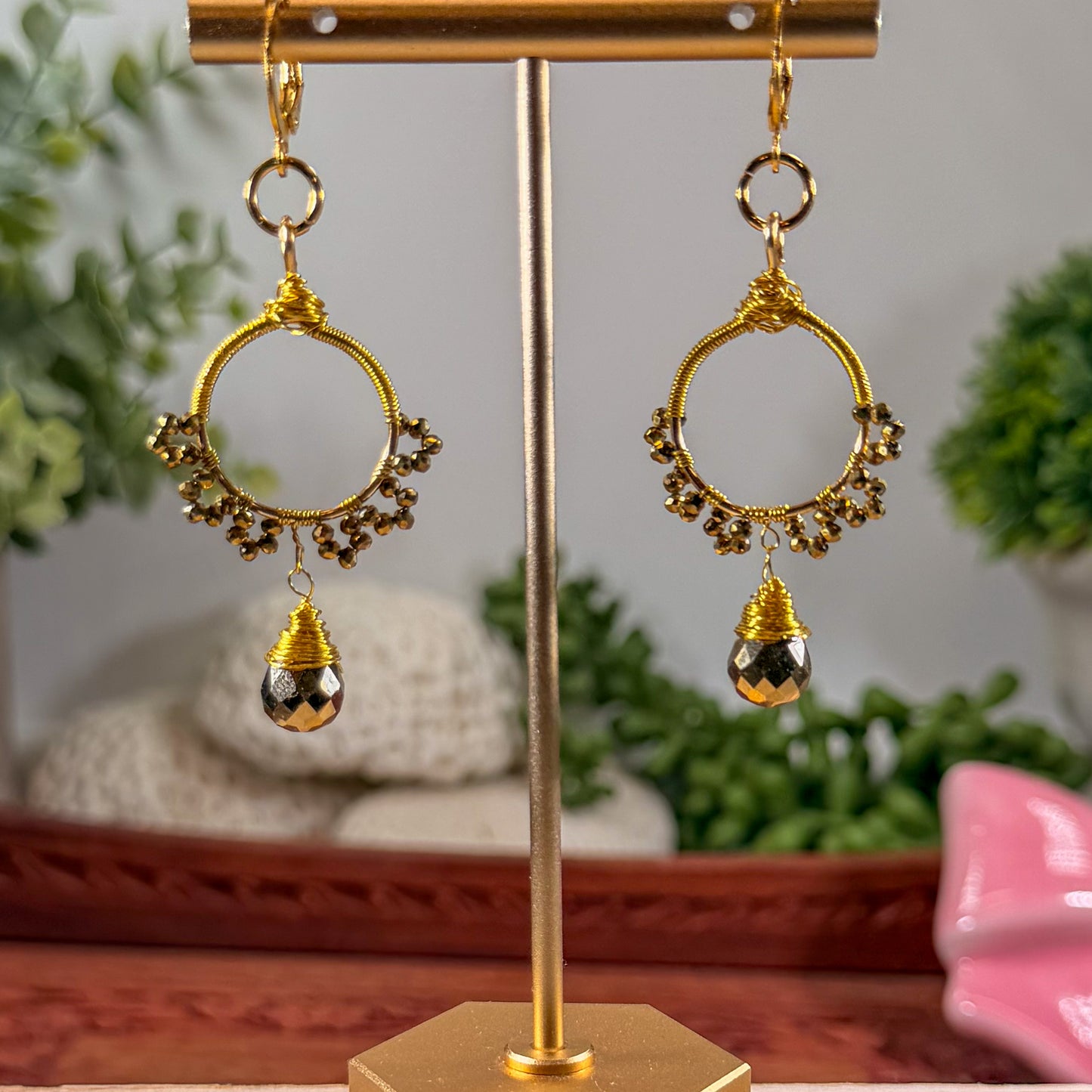 Gold sunburst hoop earrings with crystal tear drop wire wrapped charm with huggie closure and gold crystal beads