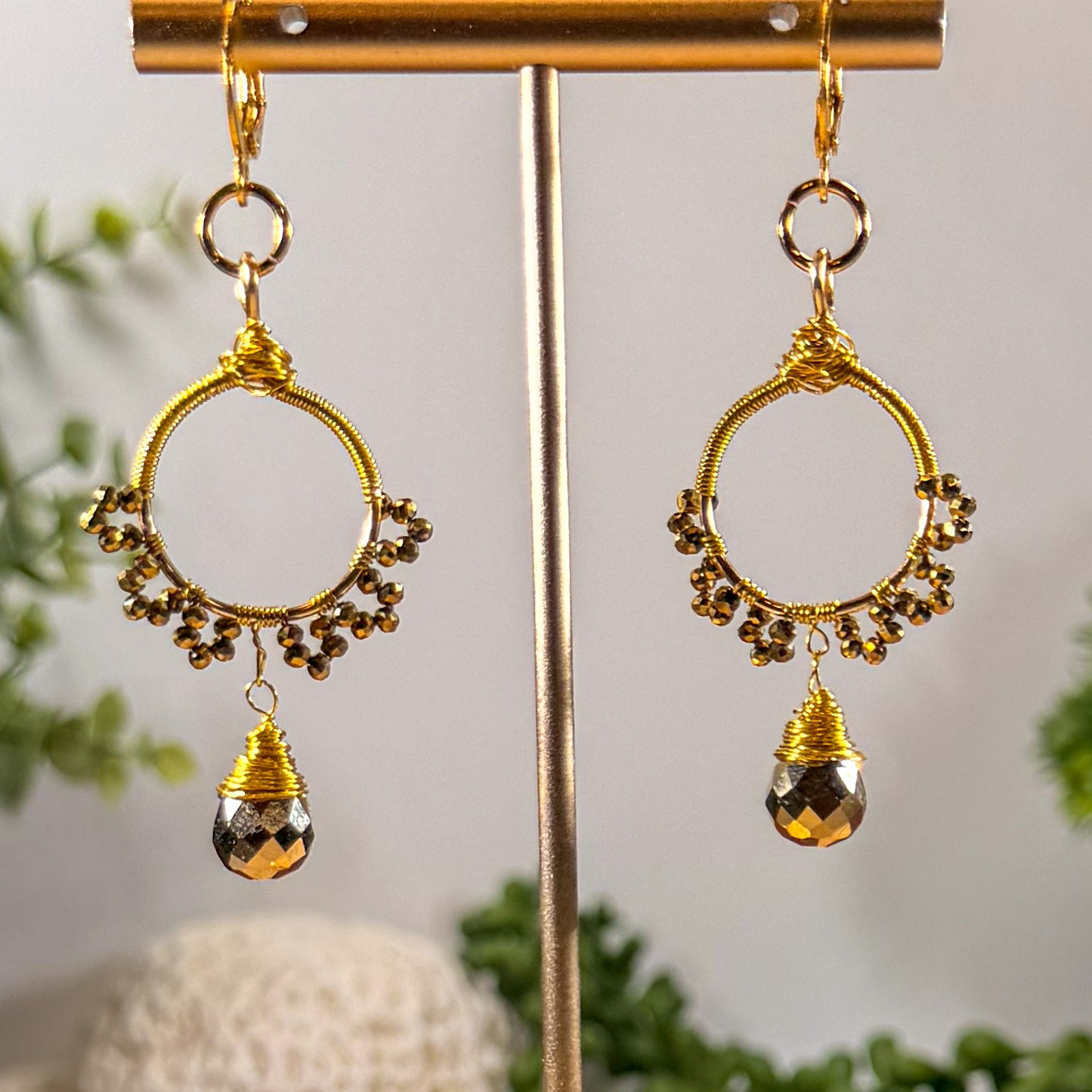 Gold sunburst hoop earrings with crystal tear drop wire wrapped charm with huggie closure and gold crystal beads